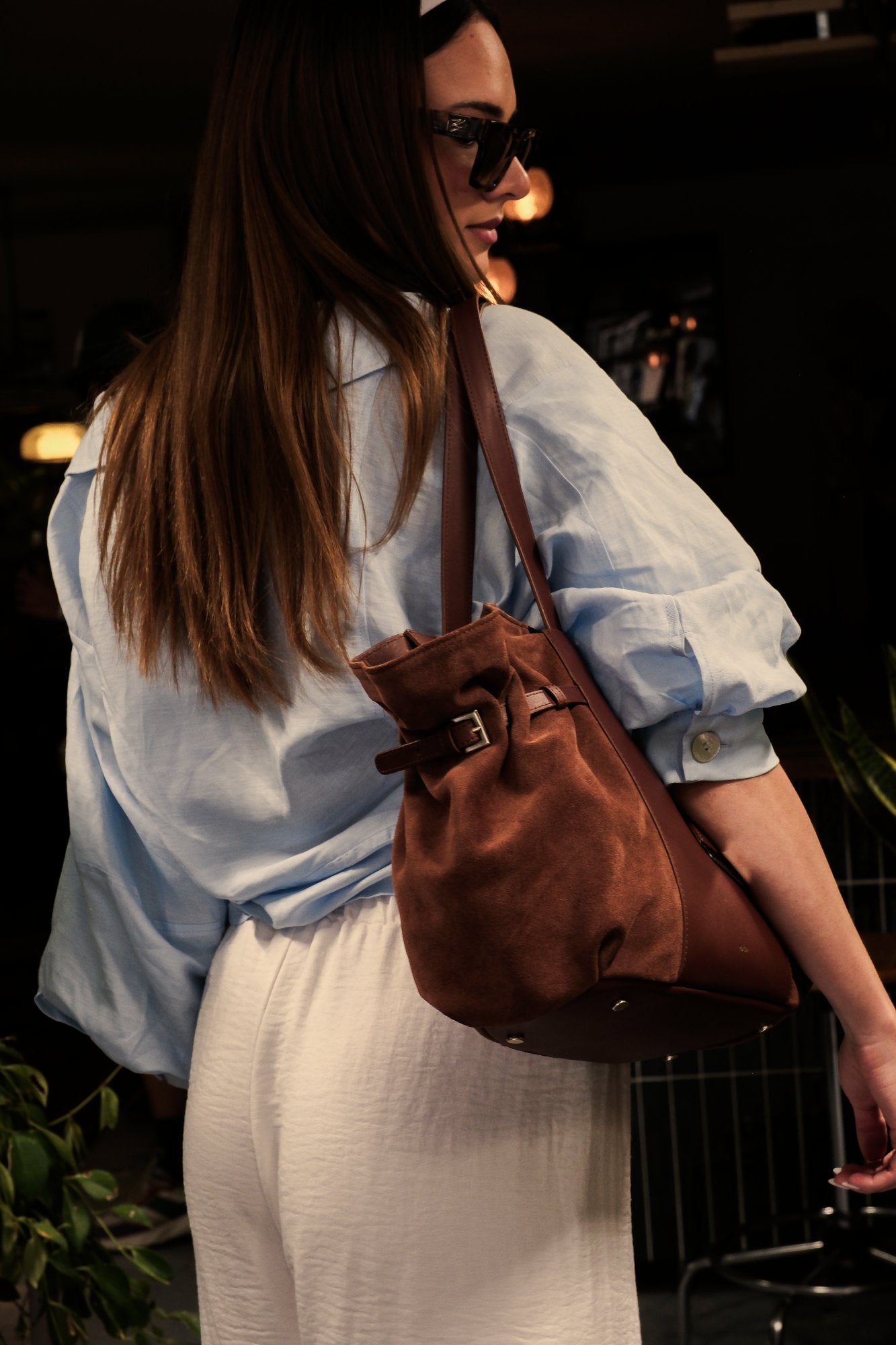 Sac cabas Célia en cuir velours marron, porté à la main